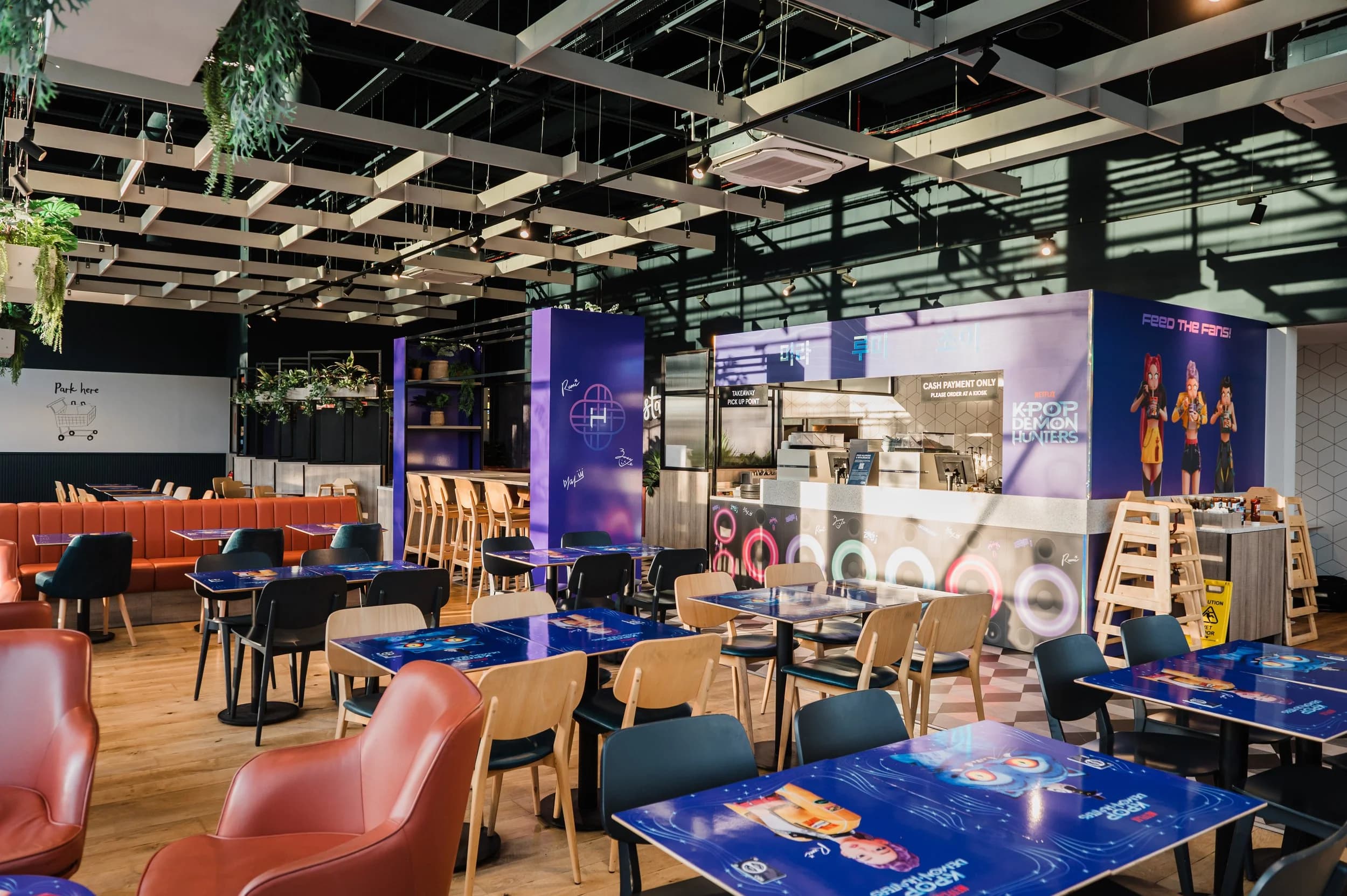A restaurant set up for a brand event, with branded blue tables