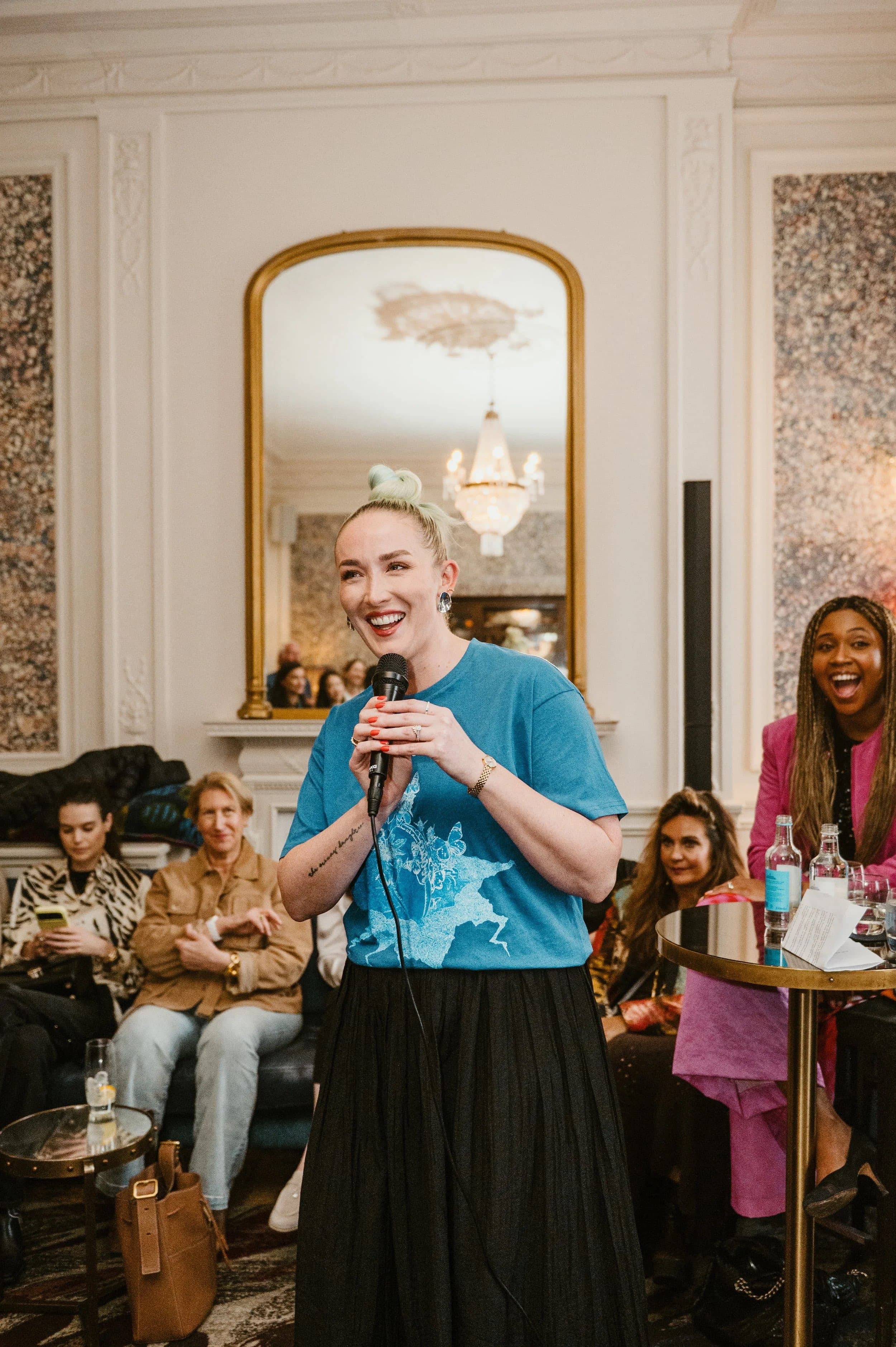 A speaker addressing guests with a microphone at a Home House launch